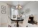 Cozy dining area featuring a round table, elegant chandelier, and tasteful decor at 2545 Banora Point Dr, Las Vegas, NV 89134