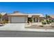 Charming single-story home with a two-car garage, desert landscaping, and a tiled roof at 2545 Banora Point Dr, Las Vegas, NV 89134