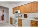 Classic kitchen provides white appliances and wood cabinets at 2545 Banora Point Dr, Las Vegas, NV 89134