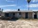 View of home's backyard featuring a covered porch and mature palm tree at 2642 San Vincente Ct, Las Vegas, NV 89115