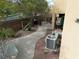 Cozy backyard featuring a paved patio area, desert landscaping, and mature tree at 2691 Benton Cove St, Laughlin, NV 89029