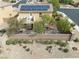Backyard featuring a stone wall, small patio, and desert landscaping at 2691 Benton Cove St, Laughlin, NV 89029