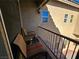 Inviting balcony featuring two chairs and small table overlooking lower portion of the backyard at 2691 Benton Cove St, Laughlin, NV 89029
