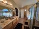 Bright bathroom featuring double sinks, a large mirror and tiled floors at 2691 Benton Cove St, Laughlin, NV 89029