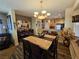 Open-concept dining area with elegant lighting, comfortable seating, and hardwood floors at 2691 Benton Cove St, Laughlin, NV 89029