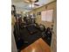 Home gym with treadmill, elliptical, free weights and mirrored wall at 2691 Benton Cove St, Laughlin, NV 89029