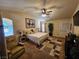 Serene main bedroom with large windows, ceiling fan, and a private en-suite bathroom at 2691 Benton Cove St, Laughlin, NV 89029