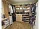 Spacious walk-in closet with custom shelving, hanging racks and carpeted floors at 2691 Benton Cove St, Laughlin, NV 89029