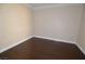 Cozy bedroom featuring neutral walls, white trim, and a dark hardwood floor at 270 E Flamingo Rd # 107, Las Vegas, NV 89169