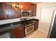 Updated kitchen featuring stone countertops, stainless steel appliances, and wood cabinets at 270 E Flamingo Rd # 107, Las Vegas, NV 89169