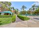 Well-manicured pool area with private cabanas, lounge chairs, and lush greenery at 270 E Flamingo Rd # 107, Las Vegas, NV 89169