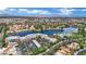 Expansive aerial view of a luxury community with lush landscaping, resort-style amenities, and stunning lake views at 3150 Soft Breezes Dr # 1040, Las Vegas, NV 89128
