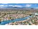 Panoramic aerial view of a residential area featuring a lake, palm trees, and mountains in the distance at 3150 Soft Breezes Dr # 1040, Las Vegas, NV 89128