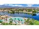 Aerial shot of a lakefront community featuring a beach, palm trees, and a blue lagoon at 3150 Soft Breezes Dr # 1040, Las Vegas, NV 89128