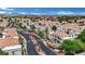 Gated community featuring well-maintained landscaping, palm trees, and a view of the Las Vegas skyline at 3150 Soft Breezes Dr # 1040, Las Vegas, NV 89128