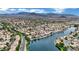 Beautiful aerial view of a lakeside community with tree-lined streets, water views, and mountain views in the distance at 3150 Soft Breezes Dr # 1040, Las Vegas, NV 89128