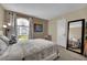 Bedroom with plush carpeting, comfortable bed, and decorative window at 3150 Soft Breezes Dr # 1040, Las Vegas, NV 89128