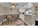 Inviting dining area with a charming table set for four, flowing into a kitchen with a view of the outdoor scenery at 3150 Soft Breezes Dr # 1040, Las Vegas, NV 89128