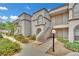 Condo featuring stucco siding, stairway access, sidewalk, and desert landscaping at 3150 Soft Breezes Dr # 1040, Las Vegas, NV 89128