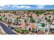 Exterior view of condos, showcasing a pool and meticulous landscaping with palm trees at 3150 Soft Breezes Dr # 1040, Las Vegas, NV 89128