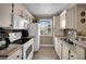 Kitchen with stone countertops and stainless steel sink next to white refrigerator at 3150 Soft Breezes Dr # 1040, Las Vegas, NV 89128