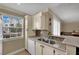 Kitchen with stainless steel sink, stone countertops, and a bright window at 3150 Soft Breezes Dr # 1040, Las Vegas, NV 89128