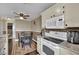 Bright eat-in kitchen featuring white appliances, wood floors, and a ceiling fan at 3150 Soft Breezes Dr # 1040, Las Vegas, NV 89128