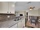 Well-lit kitchen featuring stone countertops, tile backsplash, and stainless steel sink at 3150 Soft Breezes Dr # 1040, Las Vegas, NV 89128