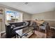 Bright and airy living room with a comfortable sofa, a fireplace, and a view of the outdoor scenery through large windows at 3150 Soft Breezes Dr # 1040, Las Vegas, NV 89128