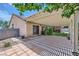 Landscaped backyard features covered patio space and direct access to house at 3220 W Hammer Ln, North Las Vegas, NV 89031