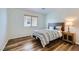 Cozy bedroom with wood flooring, a queen bed, and natural light from the window at 3220 W Hammer Ln, North Las Vegas, NV 89031