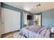 Bright bedroom with light blue walls, closet, wood-look floors, and lots of light at 3220 W Hammer Ln, North Las Vegas, NV 89031