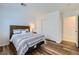 Bright bedroom with hardwood floors, closet, and a queen-size bed at 3220 W Hammer Ln, North Las Vegas, NV 89031