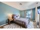 Bedroom with wood-look floors, neutral walls, nice size window, and side tables at 3220 W Hammer Ln, North Las Vegas, NV 89031