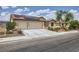 Single-story home with desert landscaping, driveway, tile roof, and solar panels at 3220 W Hammer Ln, North Las Vegas, NV 89031
