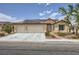 Charming single-story home featuring a desert landscape, solar panels, and a two-car garage at 3220 W Hammer Ln, North Las Vegas, NV 89031
