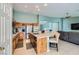 Open kitchen that features an island with seating, wood cabinets, and stainless appliances at 3220 W Hammer Ln, North Las Vegas, NV 89031