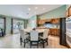 Kitchen area with a round table, seating, wooden cabinets, and a slider to the backyard at 3220 W Hammer Ln, North Las Vegas, NV 89031