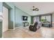 Bright living room featuring a ceiling fan, TV, large windows, and a comfortable reclining sofa at 3220 W Hammer Ln, North Las Vegas, NV 89031