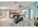 Open-concept floor plan with kitchen and living area with tile flooring and lots of natural light at 3220 W Hammer Ln, North Las Vegas, NV 89031
