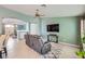 Open concept living room with large TV, console, neutral walls, and arched doorway at 3220 W Hammer Ln, North Las Vegas, NV 89031