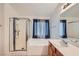 Bright main bathroom with separate shower and bathtub, vanity, and large mirror at 3220 W Hammer Ln, North Las Vegas, NV 89031