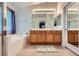 Main bathroom featuring double sinks, lots of counter space, soaking tub, and neutral colors at 3220 W Hammer Ln, North Las Vegas, NV 89031