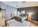 Main bedroom showcasing dark accent wall, wood-look floors, fan, and bright light at 3220 W Hammer Ln, North Las Vegas, NV 89031