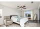 Bright bedroom with a ceiling fan, large window, comfortable bed, and cozy reading chair at 3331 Cheltenham St, Las Vegas, NV 89129