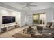 Inviting living room with comfortable sectional sofa, flat screen TV, and sliding glass doors at 3331 Cheltenham St, Las Vegas, NV 89129