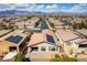 Aerial view of a neighborhood showcasing houses with solar panels and mountain views at 3621 Jasmine Heights Ave, North Las Vegas, NV 89081
