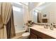 Bright bathroom features a shower-tub combo and a vanity with decorative backsplash tiles at 3621 Jasmine Heights Ave, North Las Vegas, NV 89081