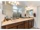 Bathroom featuring double sink vanity with decorative mirrors, and separate water closet and shower stall at 3621 Jasmine Heights Ave, North Las Vegas, NV 89081