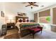 Comfortable bedroom with neutral tones, large window, ceiling fan, and stylish decor for a serene living experience at 3621 Jasmine Heights Ave, North Las Vegas, NV 89081